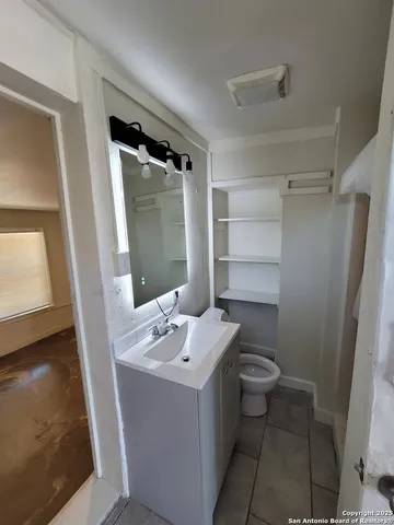 a bathroom with a sink toilet and shower