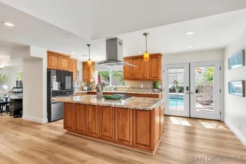 a kitchen with stainless steel appliances granite countertop a sink and wooden cabinets