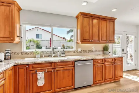 a kitchen with stainless steel appliances granite countertop a sink and cabinets