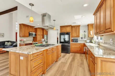 a open kitchen with stainless steel appliances granite countertop a sink stove and refrigerator