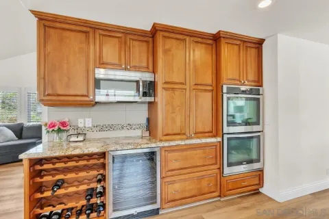 a kitchen with granite countertop cabinets and window