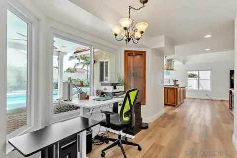 a view of a dining room with furniture and a window