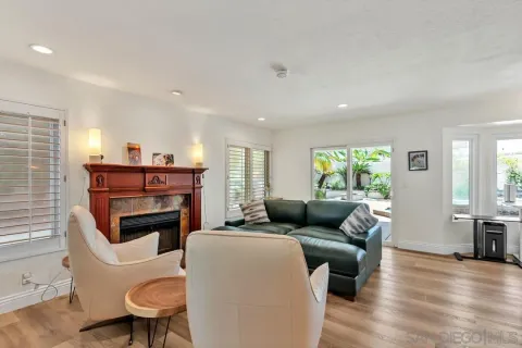 a living room with furniture a fireplace and a window