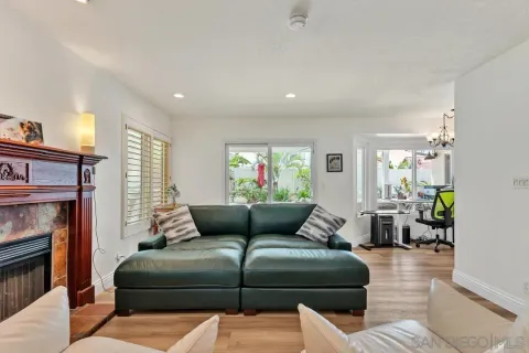 a living room with furniture a fireplace and a window