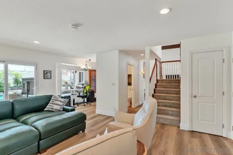 a living room with furniture and wooden floor