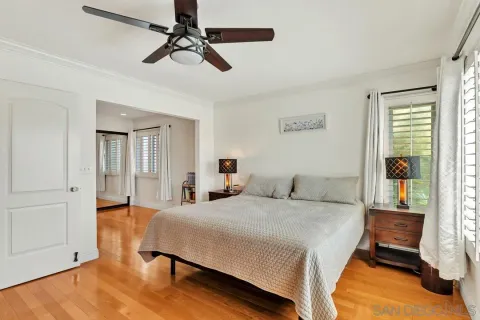 a bedroom with a bed dresser and a flat tv screen