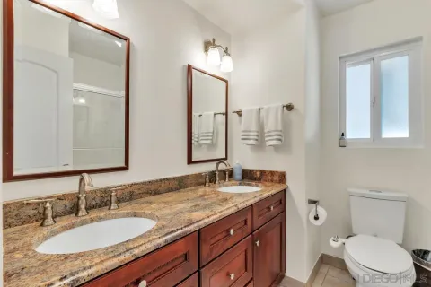 a bathroom that has a glass shower door