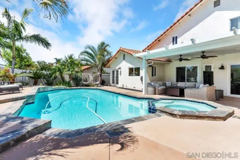 a swimming pool with outdoor seating and yard