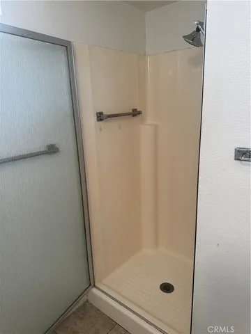 a balcony with wooden floor and outdoor seating