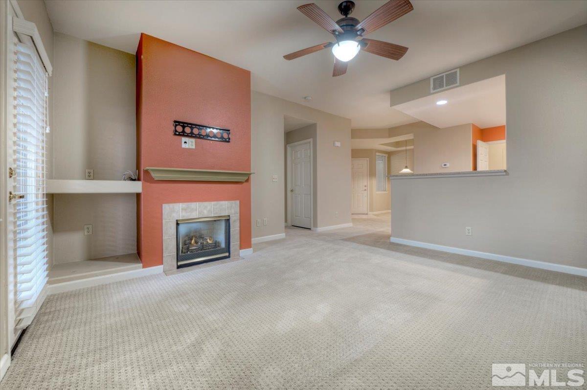 900 South Meadows Parkway, Unit 5212 Reno, NV 89521 - Photo 5 of 39 a view of a livingroom with a fireplace and a ceiling fan
