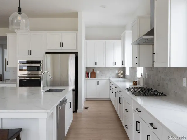 a kitchen with cabinets and stainless steel appliances