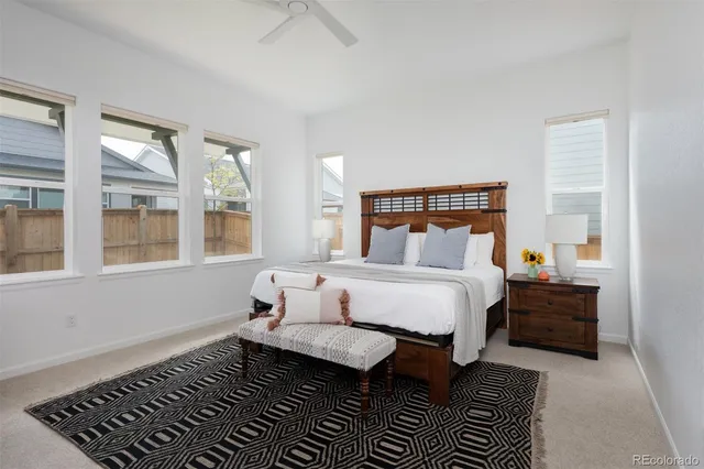 a spacious bedroom with a bed and wooden floor