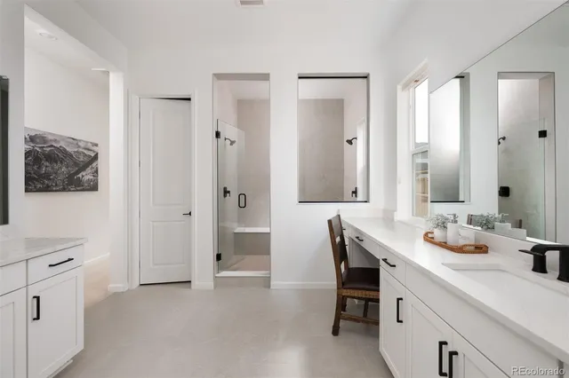 a spacious bathroom with a double vanity sink double and mirror