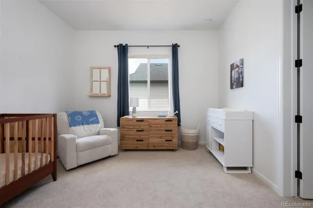 a room with furniture and baby crib
