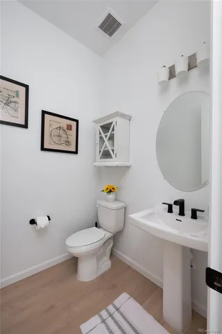 a bathroom with a toilet a sink and a mirror