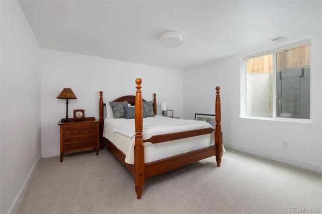 a bed room with a bed and a window