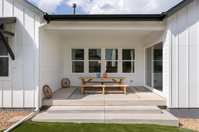 a front view of a house with a yard glass top table and chairs