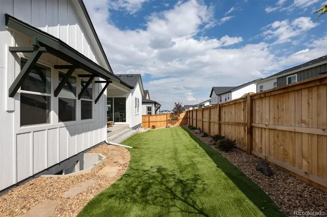 a view of house with backyard and entertaining space