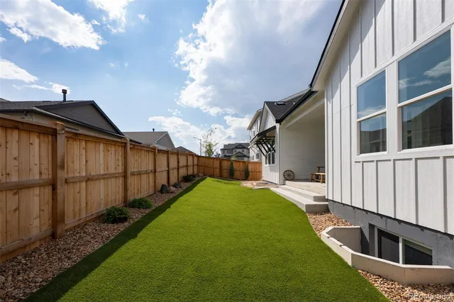 a view of a backyard with sitting area