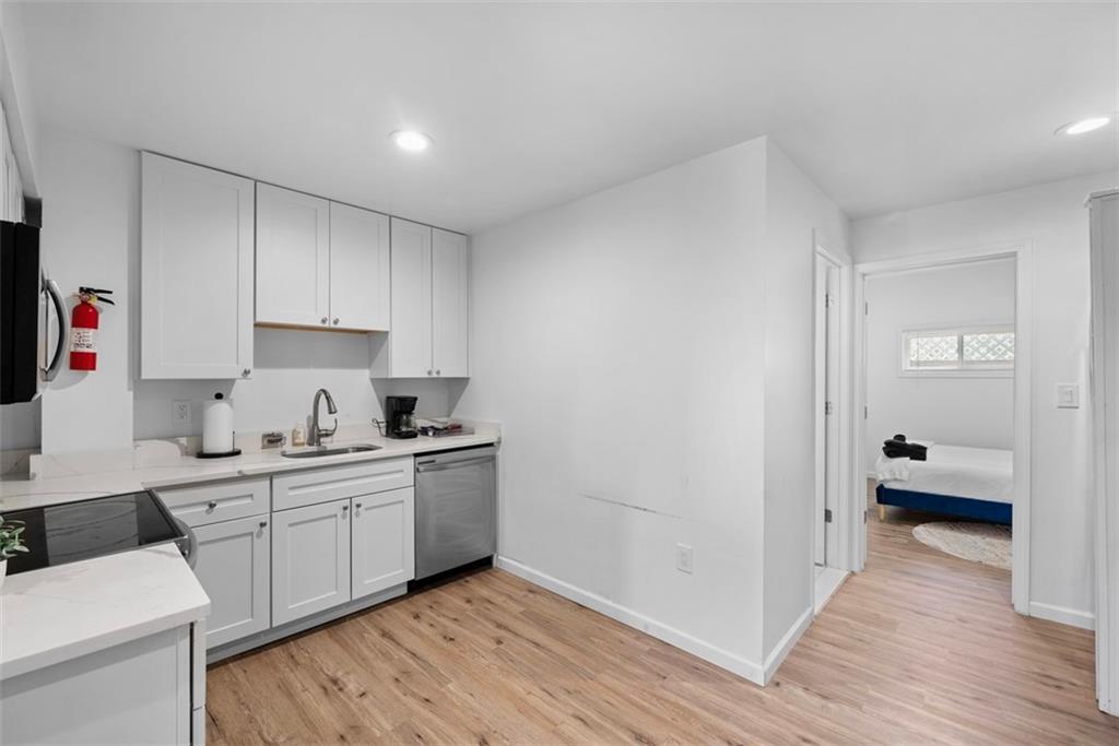 5270 Wickliff Street Pittsburgh, PA 15201 - Photo 12 of 33 a kitchen with a sink cabinets and wooden floor