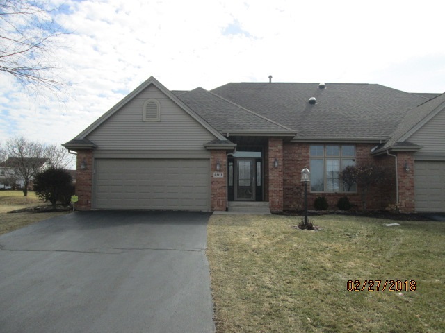 6911 Rote Road Rockford, IL 61107 - Photo 1 of 5 a view of a house with a small yard and a large window