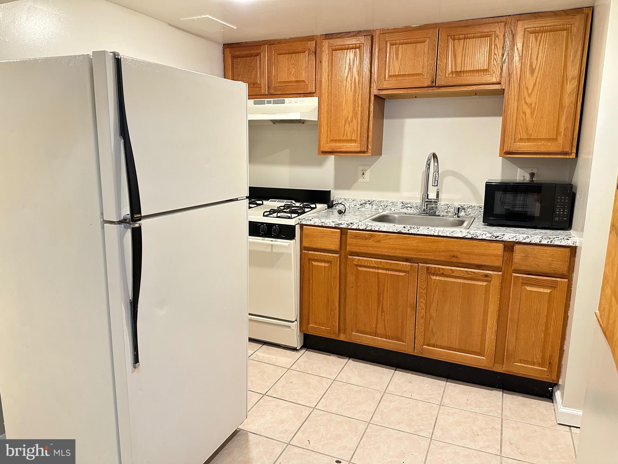 3626 12th Street Northeast Washington, DC 20017 - Photo 4 of 9 a white refrigerator freezer sitting inside of a kitchen
