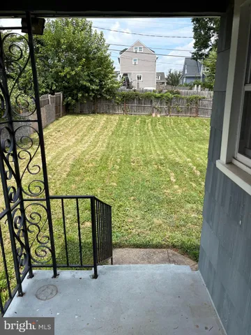a view of a balcony with floor to ceiling windows and yard