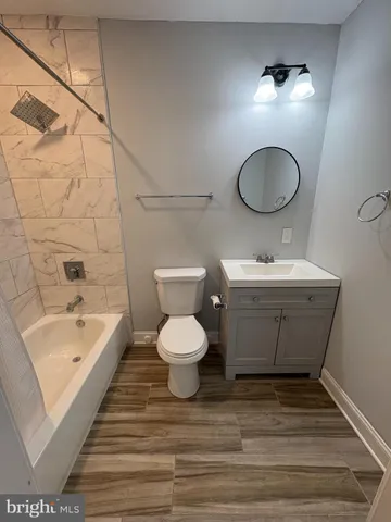 a bathroom with a sink a toilet and bathtub