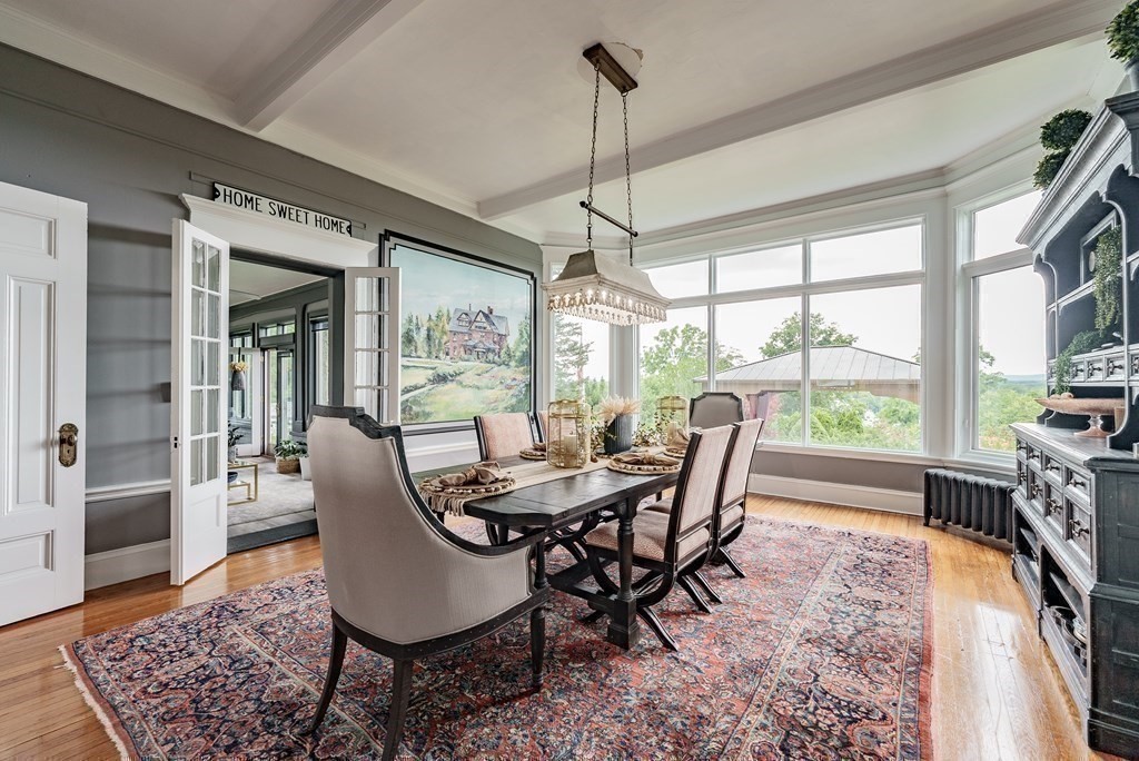 190 Longhill Street Springfield, MA 01108 - Photo 13 of 42 a dining room with furniture a chandelier and wooden floor