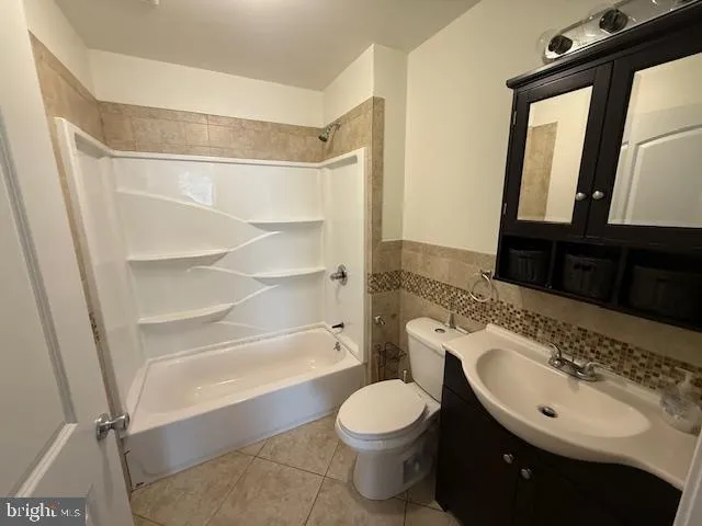 a bathroom with a sink a toilet a mirror and shower