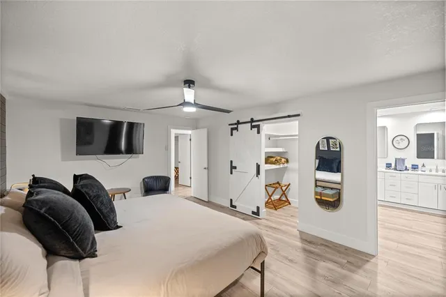 a bedroom with a bed and wooden floor