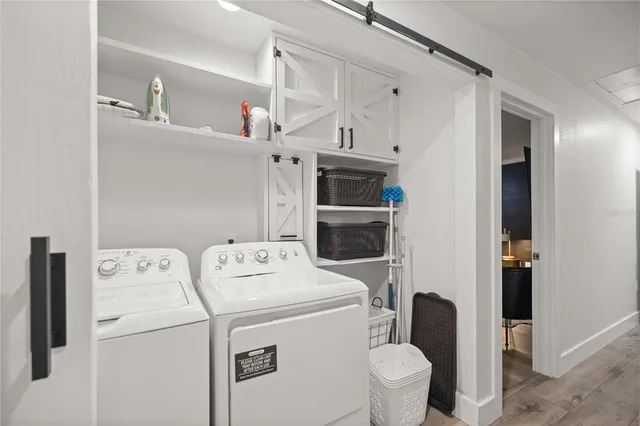 a kitchen with a sink refrigerator and cabinets