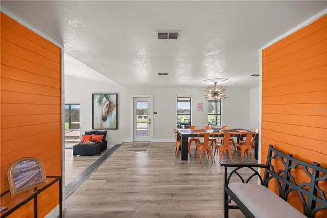 a bedroom with a bed and painting on the wall