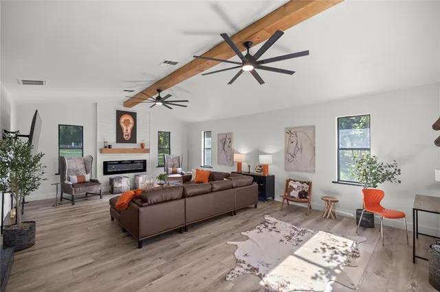 a kitchen with granite countertop white cabinets and stainless steel appliances