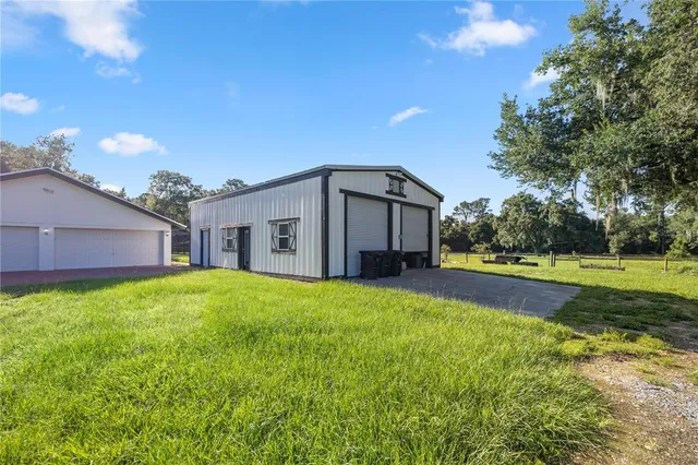 a view of a backyard with wooden floor and fence