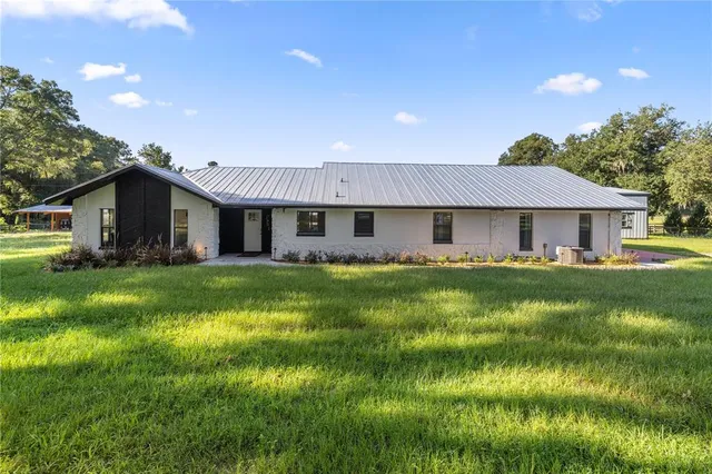a front view of a house with yard and green space