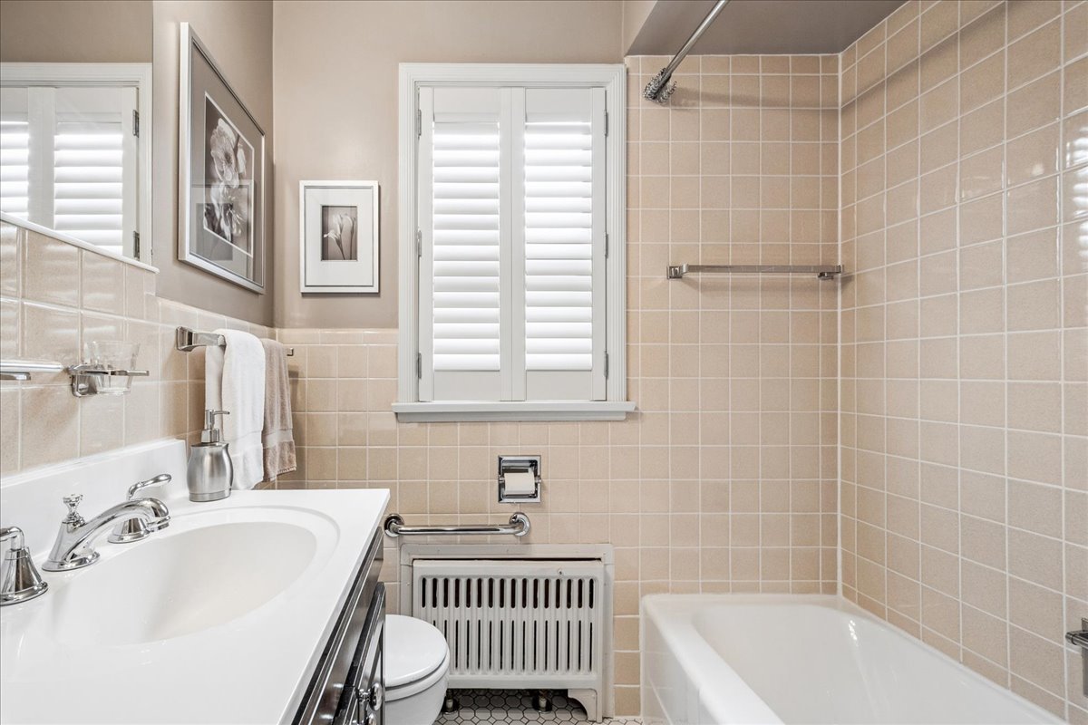 2234 Central Street, Unit 3 Evanston, IL 60201 - Photo 12 of 19 a bathroom with a bathtub a sink and a shower
