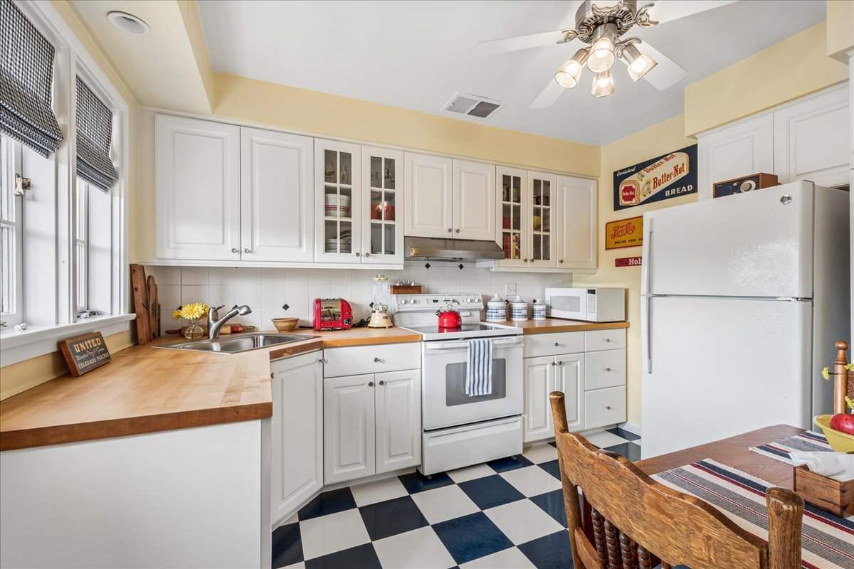 2234 Central Street, Unit 3 Evanston, IL 60201 - Photo 7 of 19 a kitchen with a sink a stove and white cabinets