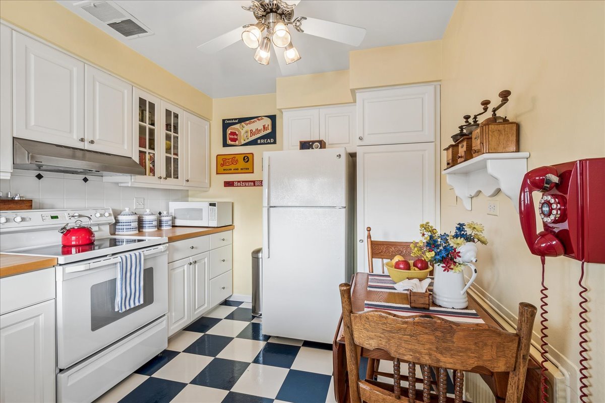2234 Central Street, Unit 3 Evanston, IL 60201 - Photo 8 of 19 a kitchen with stainless steel appliances granite countertop a refrigerator sink stove and white cabinets