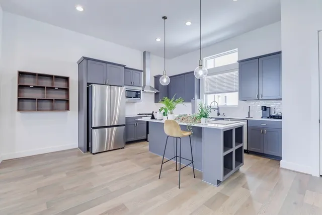 a view of a kitchen counter space with wooden floor