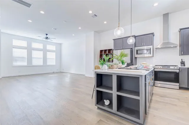a stove top oven sitting inside of a kitchen