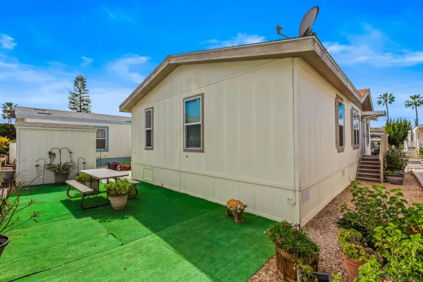 a backyard of a house with table and chairs
