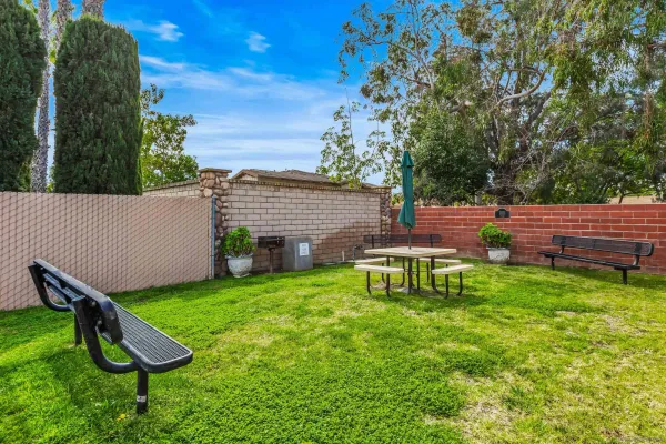 a view of a backyard with table and chairs