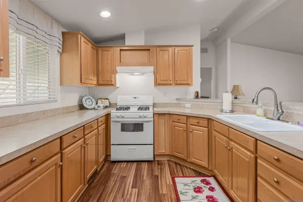 a kitchen with a sink stove and cabinets