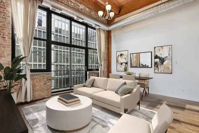 a living room with furniture and a floor to ceiling window
