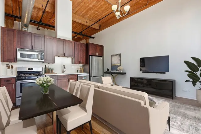 a kitchen with stainless steel appliances a stove refrigerator sink and microwave