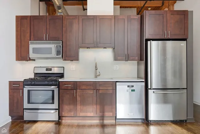a kitchen with appliances and cabinets
