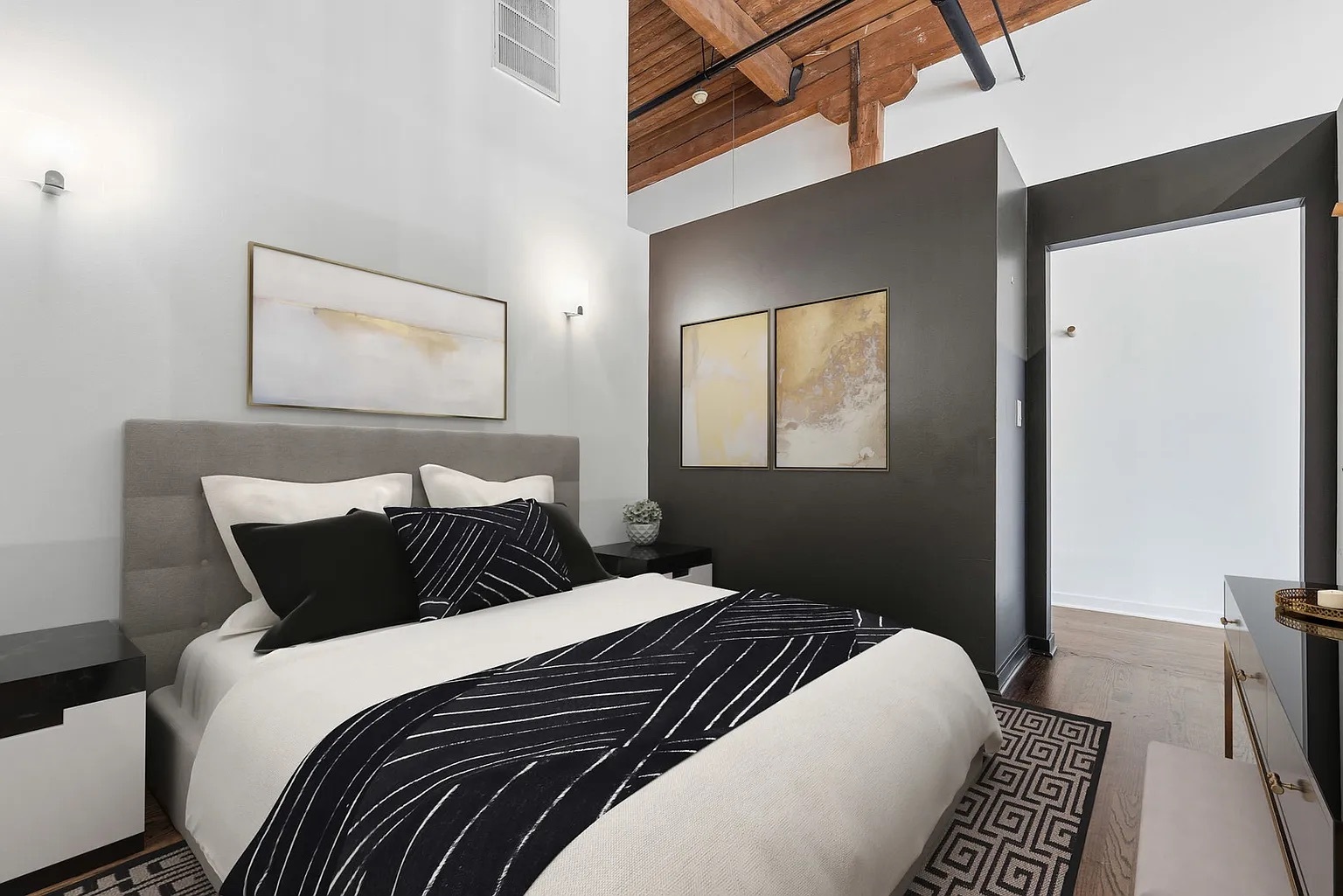 215 North Aberdeen Street, Unit 607B Chicago, IL 60607 - Photo 7 of 12 a bedroom with a bed and wooden floor