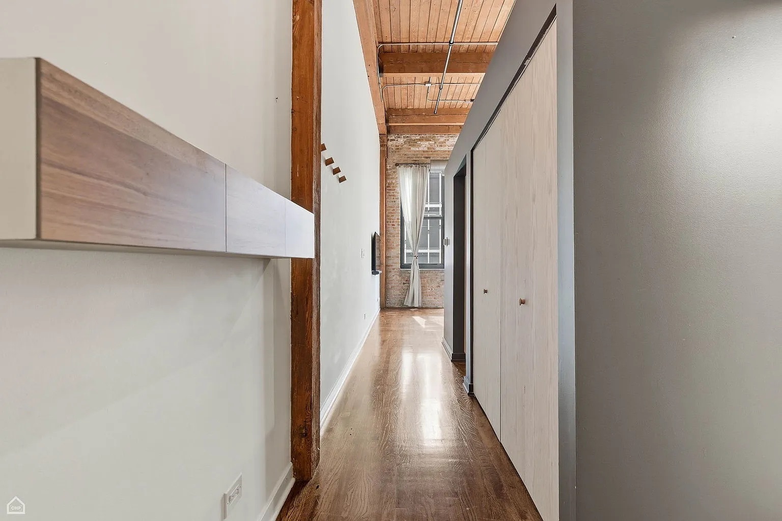 215 North Aberdeen Street, Unit 607B Chicago, IL 60607 - Photo 8 of 12 a view of a hallway with wooden floor and staircase