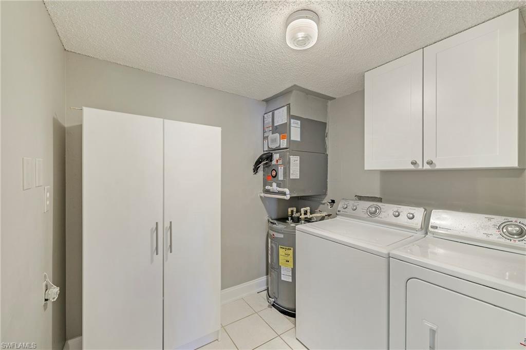 5737 Whitaker Road, Unit C103 Naples, FL 34112 - Photo 18 of 22 a utility room with dryer and washer